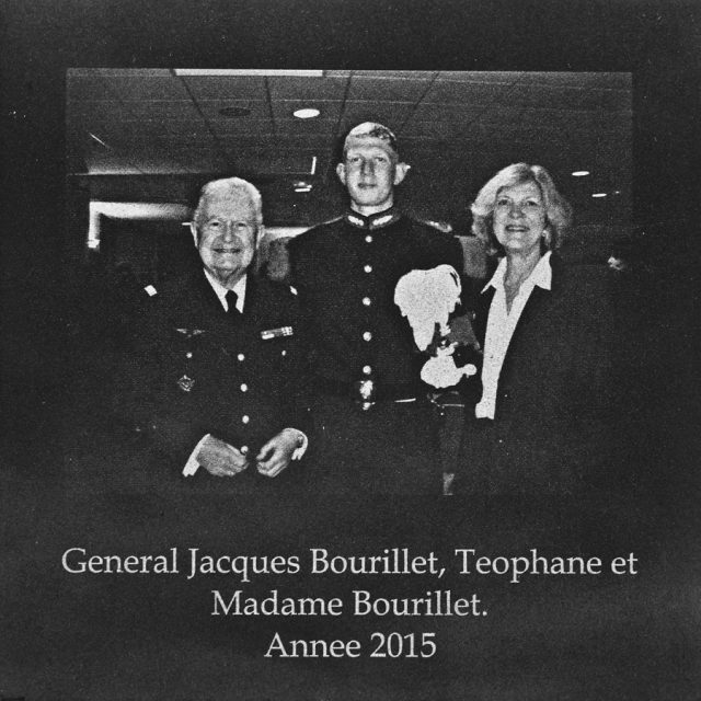 An older man in military uniform and an older woman stand on either side of a young man in military uniform engraved on marble panel at Maze of Honor