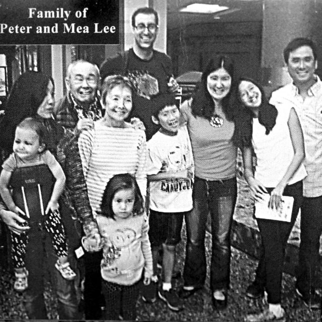 A family stands posing for a photo