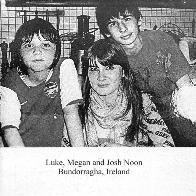 A young teenage female and her two brothers pose for a photograph