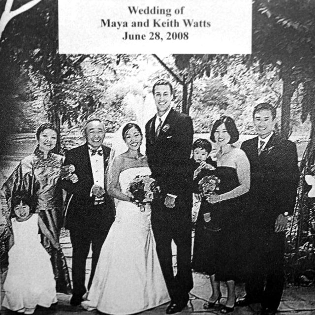 Married couple stand with family engraved on marble panel for Maze of Honor