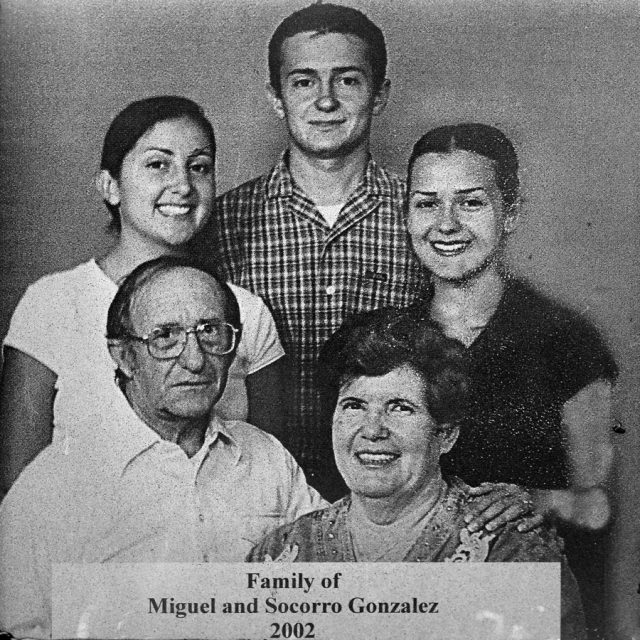 Engraving of an older man and woman and their three children pose smiling on a marble panel at the Maze of Honor