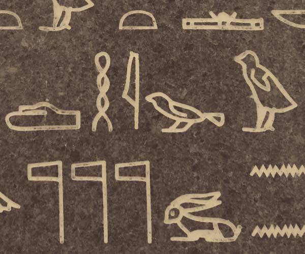 Egyptian hieroglyphs engraved on granite tile at museum of history in granite