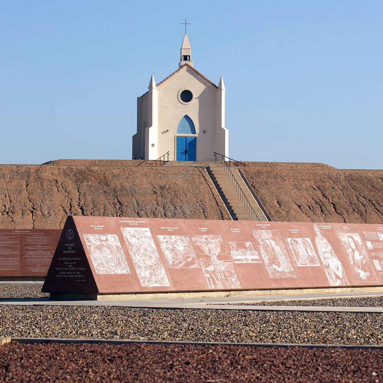 Missouri Red granite monument etched with Renaissance masterpieces in front of the Church on the Hill near Yuma, Arizona
