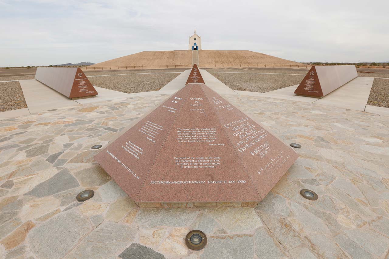 History of Humanity in Granite Rosetta Stone etched with multiple languages in front of the Hill of Prayer and the Church on the Hill