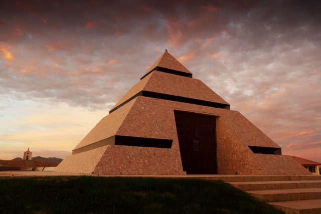 Center of the World pyramid against a cotton candy sky at sunset