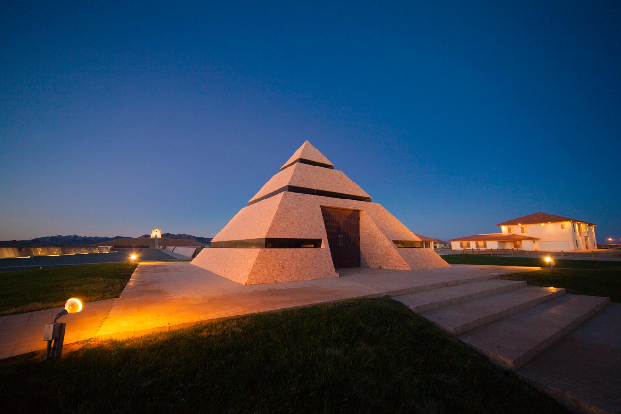 The pyramid at the Center of the World constructed of granite and glass lit up at dusk