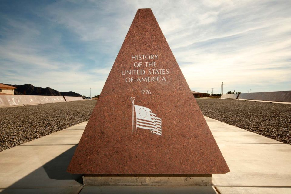 Missouri Red granite monument etched with the History of the United States of America and a flag with the 13 original colonies