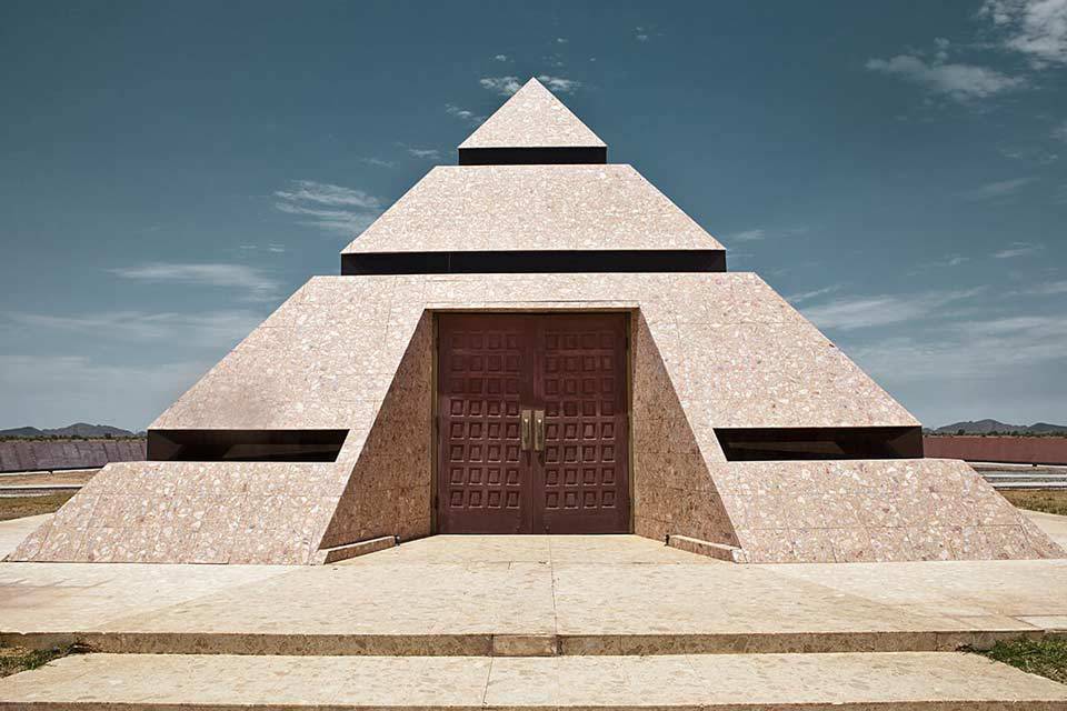 Center of the World pyramid constructed of granite and glass with two large wooden doors in Felicity, CA