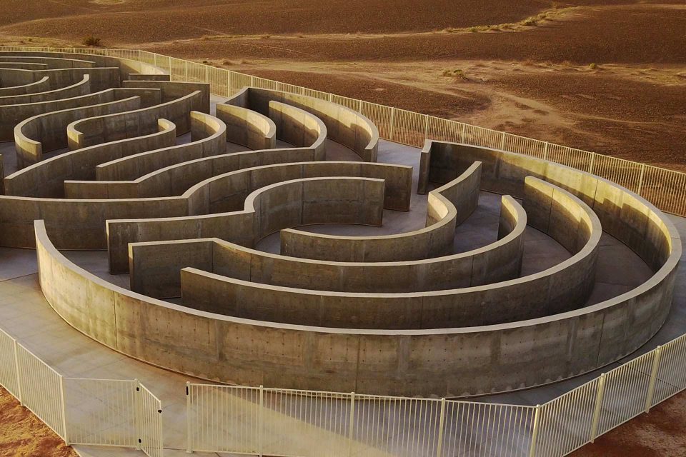 History of Humanity in Granite Maze of Honor surrounded by a white metal fence